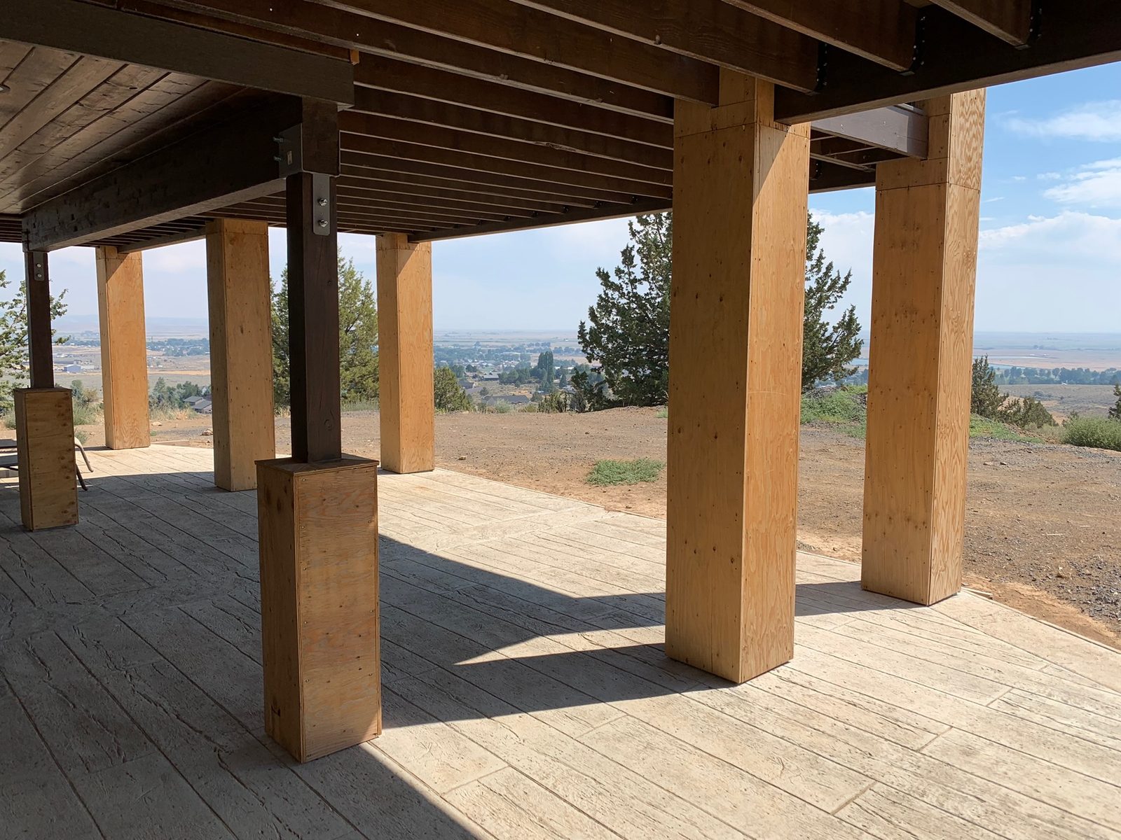 Covered residential porch and deck area maintained and ready for seasonal use.