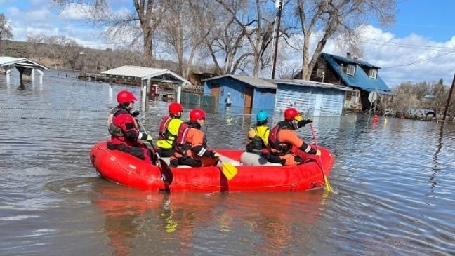 Crew responding to active water intrusion and flood cleanup conditions.
