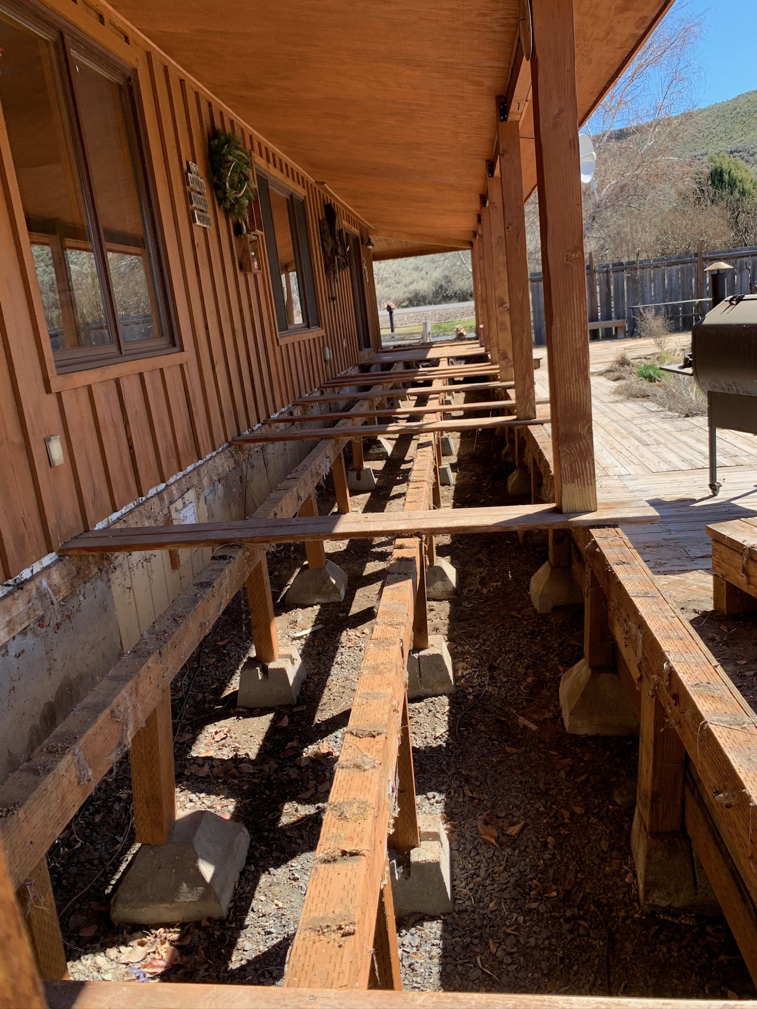 Deck or porch rebuild in progress with visible structural and finish work.